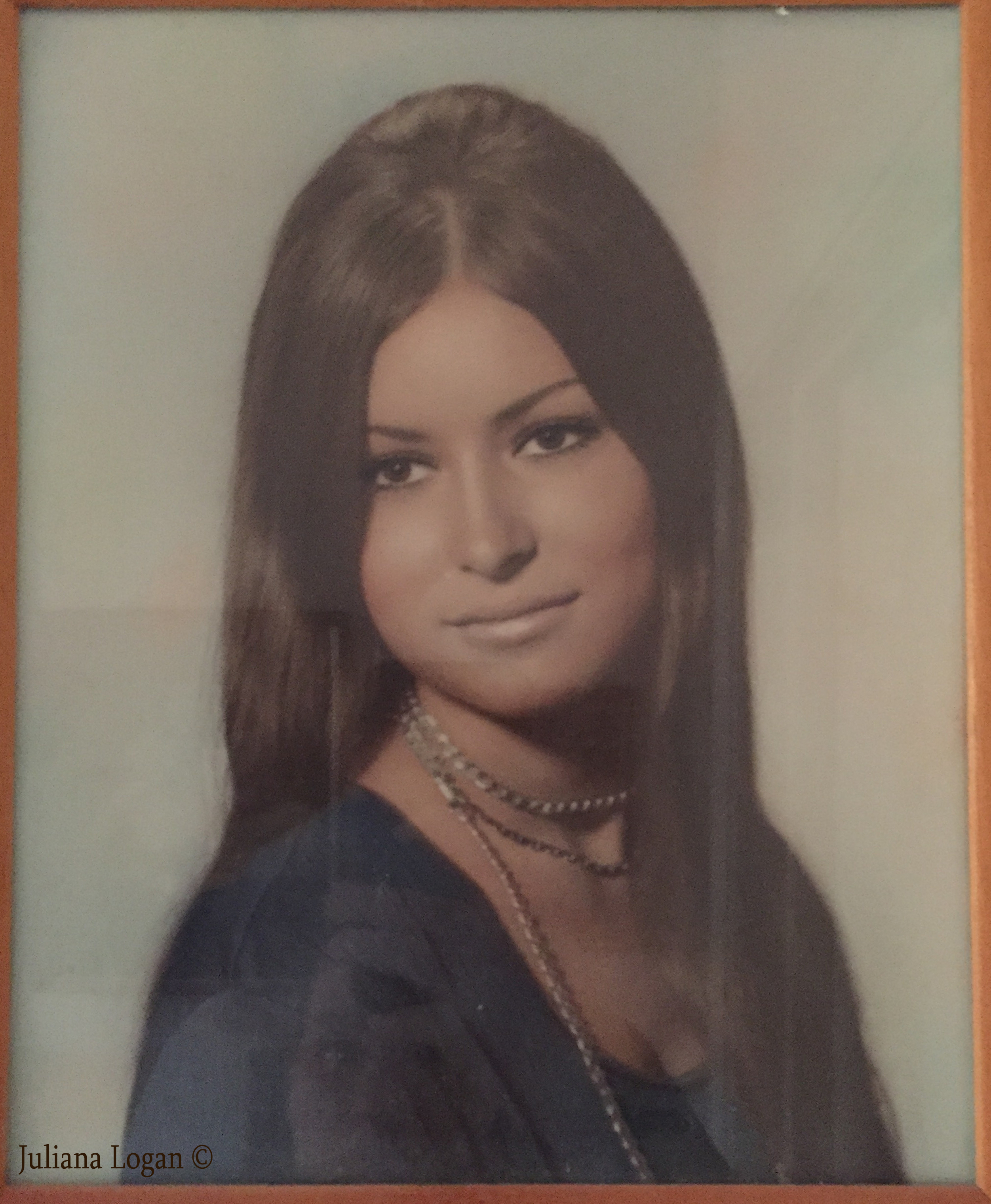 Img: Sue looking over her right shoulder in her high school senior portrait