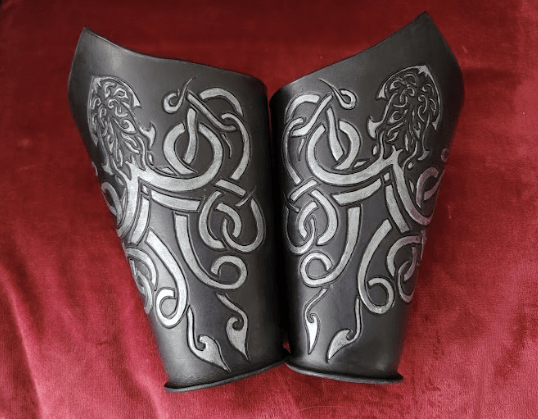Black and silver kraken bracers on a red velvet background