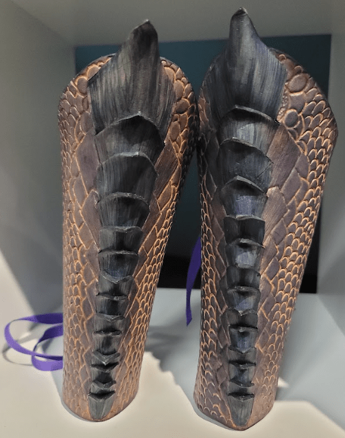 purple dragon scale bracers in a white box