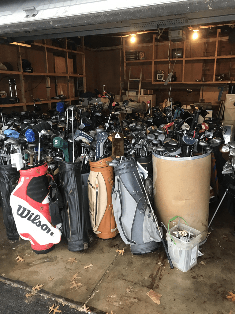 Likely hundreds of golf clubs in a garage