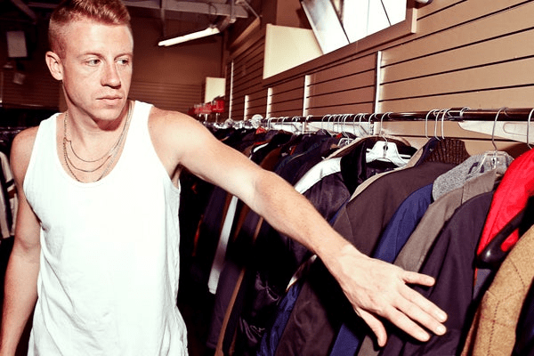 Macklemore touching jackets at a thrift shop